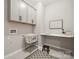 Bright laundry room features upper cabinets, a utility sink, and ample counter space at 1082 Dorsey Dr, Fort Mill, SC 29715