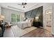 Inviting main bedroom featuring a decorative accent wall, tray ceiling, and ample natural light at 1082 Dorsey Dr, Fort Mill, SC 29715
