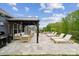 Outdoor patio area featuring a pergola, dining table, and lounge chairs, perfect for outdoor living and relaxation at 1082 Dorsey Dr, Fort Mill, SC 29715