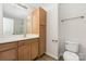 Functional bathroom with a built-in vanity, storage cabinet, and a toilet at 11029 Ardglass Ct, Charlotte, NC 28213