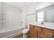 Bathroom featuring a tub/shower combination and a vanity with wood cabinets at 11029 Ardglass Ct, Charlotte, NC 28213