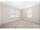 Bright, carpeted bedroom with two windows, offering ample natural light at 11029 Ardglass Ct, Charlotte, NC 28213