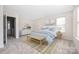 Serene bedroom with neutral tones, a bench, and coordinating decor at 11029 Ardglass Ct, Charlotte, NC 28213