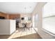 Bright dining area with laminate floors, large window and sliding glass door providing ample natural light at 11029 Ardglass Ct, Charlotte, NC 28213