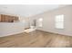 Open dining area with hardwood floors, large window and sliding glass door providing ample natural light at 11029 Ardglass Ct, Charlotte, NC 28213