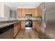 Well-equipped kitchen with stainless steel appliances, granite countertops, and wood cabinets at 11029 Ardglass Ct, Charlotte, NC 28213