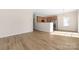 Open living space with hardwood floors seamlessly integrating the living room, dining area, and kitchen at 11029 Ardglass Ct, Charlotte, NC 28213