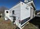 Exterior view of the camper showcasing its modern design and outdoor hookups at 114 Dove Ln, New London, NC 28127