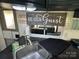 Kitchen featuring dark cabinets, stainless steel appliances, and decor at 114 Dove Ln, New London, NC 28127
