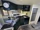 Efficient kitchen featuring dark cabinets, stainless steel appliances, and wood look flooring at 114 Dove Ln, New London, NC 28127