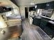 Cozy RV interior featuring a dinette table, comfortable seating, and a TV for relaxation at 114 Dove Ln, New London, NC 28127