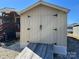 The shed features double doors with a wooden ramp for easy access and secure storage at 114 Dove Ln, New London, NC 28127