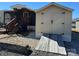 Exterior view of a beige shed with a ramp and black hardware near the house at 114 Dove Ln, New London, NC 28127
