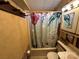 Bathroom featuring a shower with themed shower curtain and vanity with storage at 117 Badin Lake Cir, New London, NC 28127