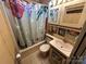 Bathroom featuring a shower with themed shower curtain and vanity with storage at 117 Badin Lake Cir, New London, NC 28127