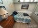 Bedroom with a twin bed, dresser, and wall decorations at 117 Badin Lake Cir, New London, NC 28127