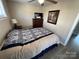 Tranquil bedroom featuring a full bed with a coordinated bedroom set, creating a peaceful and organized retreat at 117 Badin Lake Cir, New London, NC 28127