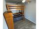 Functional bedroom with a wooden bunk bed and a small dresser, perfect for maximizing space and providing a cozy sleeping arrangement at 117 Badin Lake Cir, New London, NC 28127