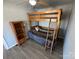 Cozy bedroom with a wooden bunk bed, matching bookcase, and a ceiling fan at 117 Badin Lake Cir, New London, NC 28127