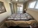 Bright bedroom with a full bed and a sliding glass door to the outdoor area, seamlessly blending indoor and outdoor living at 117 Badin Lake Cir, New London, NC 28127
