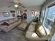 Comfortable living room with water views, featuring plush sofas and an open concept design at 117 Badin Lake Cir, New London, NC 28127