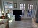 Inviting living room with large windows, cozy seating, and access to an outdoor deck at 117 Badin Lake Cir, New London, NC 28127