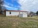 Backyard view of the home with a storage shed and white vinyl siding at 134 Garett Ln, Harmony, NC 28634