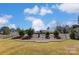Landscaped backyard with a spacious lawn, a charming wooden fence, and mature trees at 1362 Copper Creek Ln, Fort Mill, SC 29715