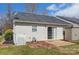 Backyard view featuring vinyl siding, gray roof, sliding glass door, small patio, and a storage shed at 1362 Copper Creek Ln, Fort Mill, SC 29715