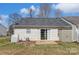 Backyard view featuring vinyl siding, gray roof, sliding glass door, small patio, and a storage shed at 1362 Copper Creek Ln, Fort Mill, SC 29715