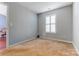Bedroom featuring neutral carpet and natural light from a window with white shutters at 1362 Copper Creek Ln, Fort Mill, SC 29715