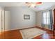 Spacious bedroom featuring hardwood floors, a ceiling fan, and natural light at 1362 Copper Creek Ln, Fort Mill, SC 29715