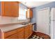 Galley kitchen featuring wood cabinets, neutral countertops and stainless sink at 1362 Copper Creek Ln, Fort Mill, SC 29715