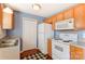 Galley kitchen with wood cabinets, neutral countertops and black and white flooring at 1362 Copper Creek Ln, Fort Mill, SC 29715