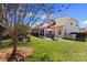 Spacious backyard with lush green grass, outdoor seating, and screened-in porch at 16032 Hollingbourne Rd, Huntersville, NC 28078