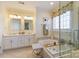Bright bathroom with dual vanity sinks, soaking tub and separate shower with glass door at 16032 Hollingbourne Rd, Huntersville, NC 28078