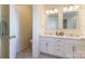 Bright bathroom features a double sink vanity, tiled floors, and neutral paint colors at 16032 Hollingbourne Rd, Huntersville, NC 28078