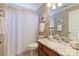 Full bathroom features a granite countertop, decorative art and a shower with white curtain at 16032 Hollingbourne Rd, Huntersville, NC 28078