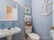 Nautical-themed powder room with pedestal sink and decorative anchor at 16032 Hollingbourne Rd, Huntersville, NC 28078