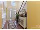 Welcoming entryway features hardwood floors, staircase, and elegant decor at 16032 Hollingbourne Rd, Huntersville, NC 28078