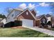 Attractive home featuring a brick facade, manicured lawn, and attached two car garage at 16032 Hollingbourne Rd, Huntersville, NC 28078