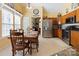 Eat-in kitchen offers stainless steel appliances, wooden cabinetry, and tile floors at 16032 Hollingbourne Rd, Huntersville, NC 28078