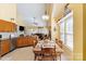 Bright kitchen featuring stainless steel appliances and a breakfast nook overlooking the living area at 16032 Hollingbourne Rd, Huntersville, NC 28078