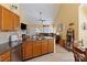 Open kitchen overlooks living room with granite counters, stainless appliances, and a central island at 16032 Hollingbourne Rd, Huntersville, NC 28078