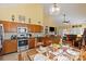 Bright kitchen featuring stainless steel appliances and a breakfast nook overlooking the living area at 16032 Hollingbourne Rd, Huntersville, NC 28078