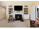 Bright and airy living room with vaulted ceiling, fireplace, built-in shelving, and access to the outdoors at 16032 Hollingbourne Rd, Huntersville, NC 28078