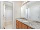 Bright bathroom with a single granite vanity and shower-tub combo at 1720 Dewberry Pl, Salisbury, NC 28146