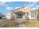 Inviting home showcasing a covered porch with stone pillars, a well-manicured lawn, and a detached garage at 1720 Dewberry Pl, Salisbury, NC 28146
