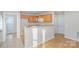 Kitchenette features a granite bar, sink, wood cabinets, and an open doorway at 1720 Dewberry Pl, Salisbury, NC 28146