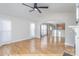 Bright living room featuring wood floors, an open floor plan, and a white fireplace at 1720 Dewberry Pl, Salisbury, NC 28146